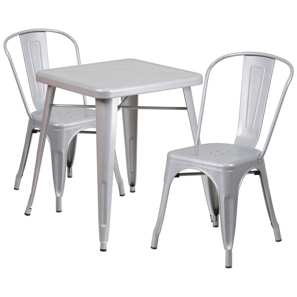 A silver metal Flash Furniture table with two stack chairs.