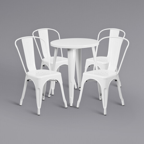 A white metal table with 4 white chairs.
