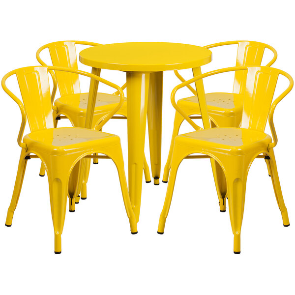 A Flash Furniture yellow metal table and chairs set on an outdoor patio.