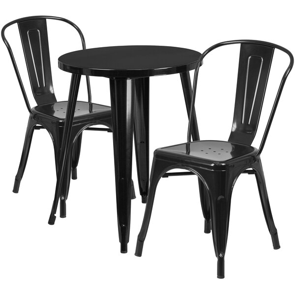 A black metal table with two black metal chairs.