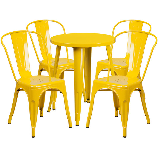 A yellow metal round table with 4 yellow metal chairs.