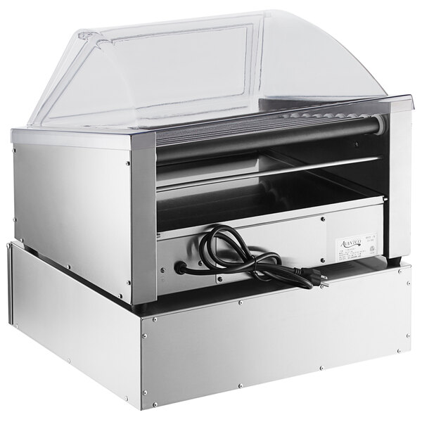 An Avantco slanted silver hot dog roller with a clear sneeze guard over it.