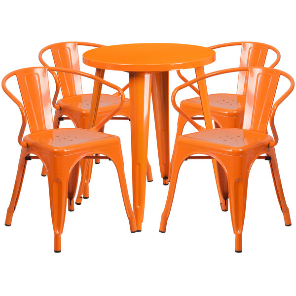 An orange metal table with four orange metal chairs.