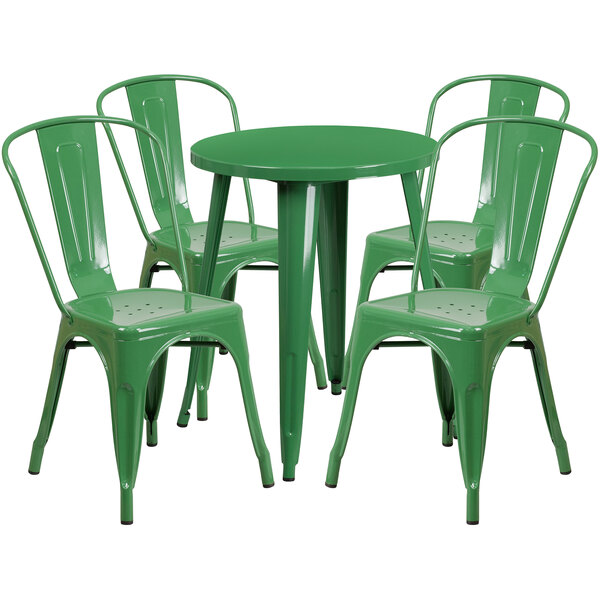 A green metal table with four chairs set outside.