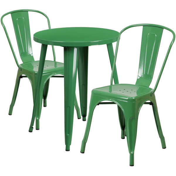 A green metal table and two green metal chairs.
