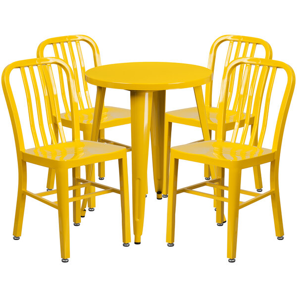 A yellow metal table with yellow chairs around it.