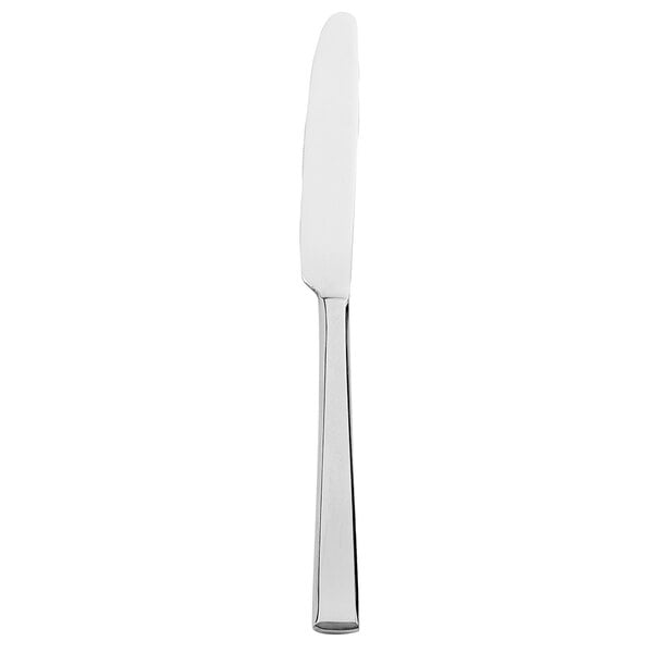 A Walco Baypoint stainless steel table knife with a white handle.