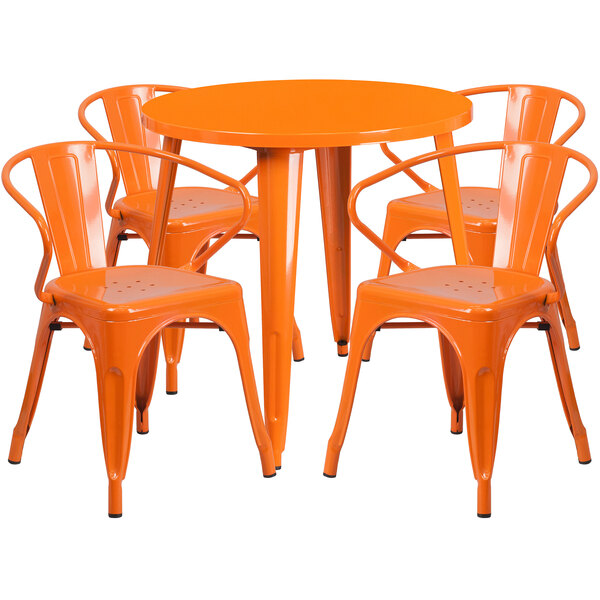An orange metal table and 4 chairs.