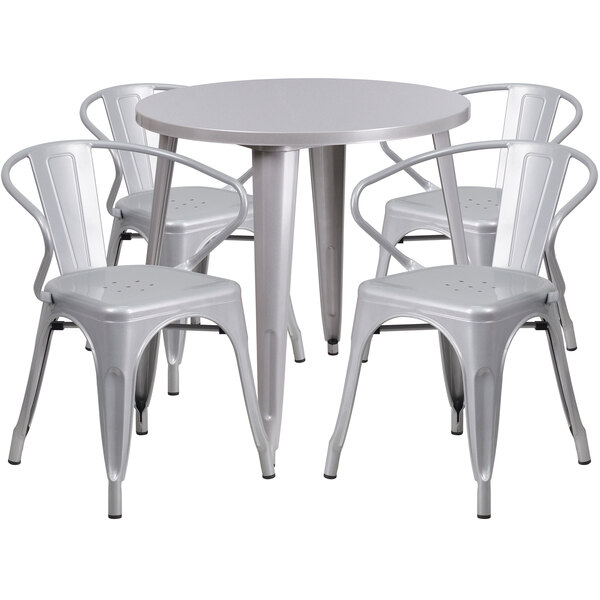 A Flash Furniture silver metal table and chairs set with white seats.