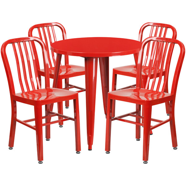 A red metal table with four red chairs.