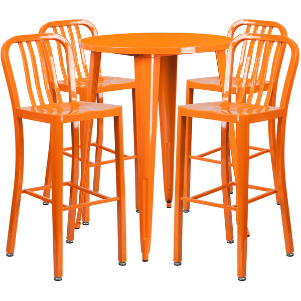 An orange metal round bar table with 4 orange stools.