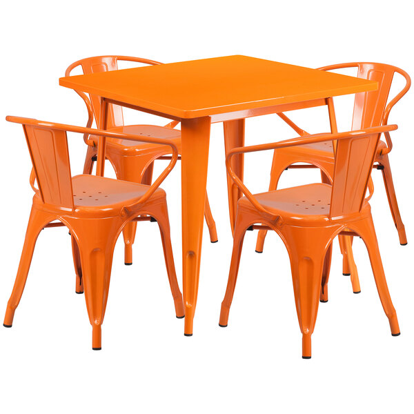 An orange square table with chairs set on an outdoor patio.