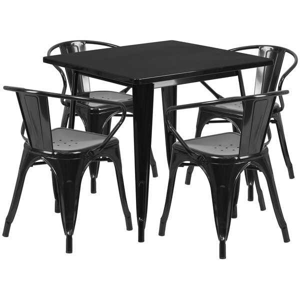 A black metal square table with four black chairs on an outdoor patio.