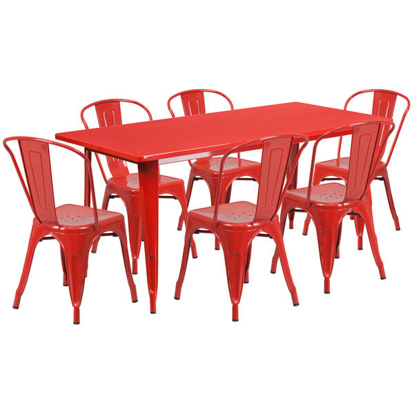 A red rectangular metal table with red chairs.