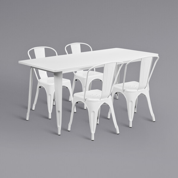 A white metal rectangular dining table with white metal chairs.