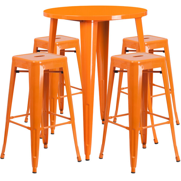 An orange metal round bar table surrounded by four square orange backless stools.