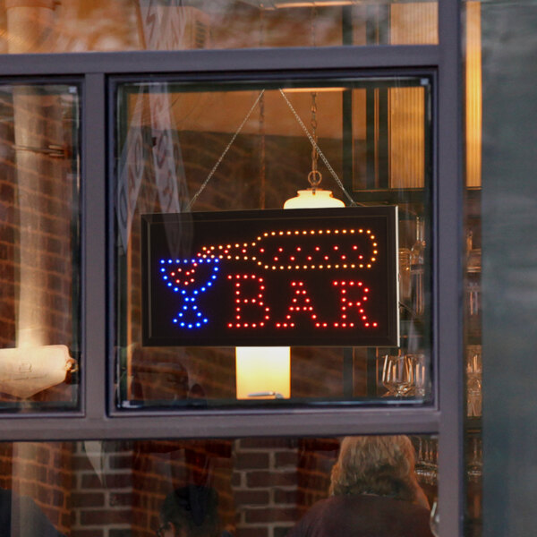 A Choice LED rectangular multicolor bar sign lit up in a window.