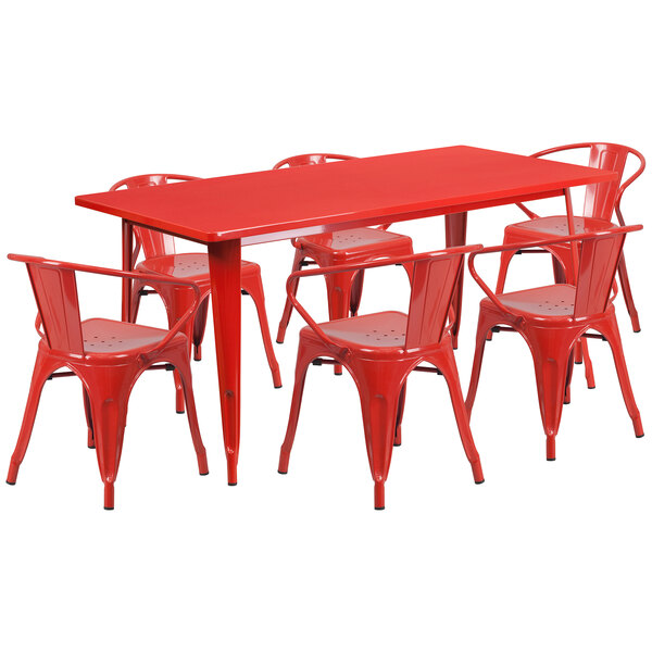 A red metal Flash Furniture table and chairs on an outdoor patio.