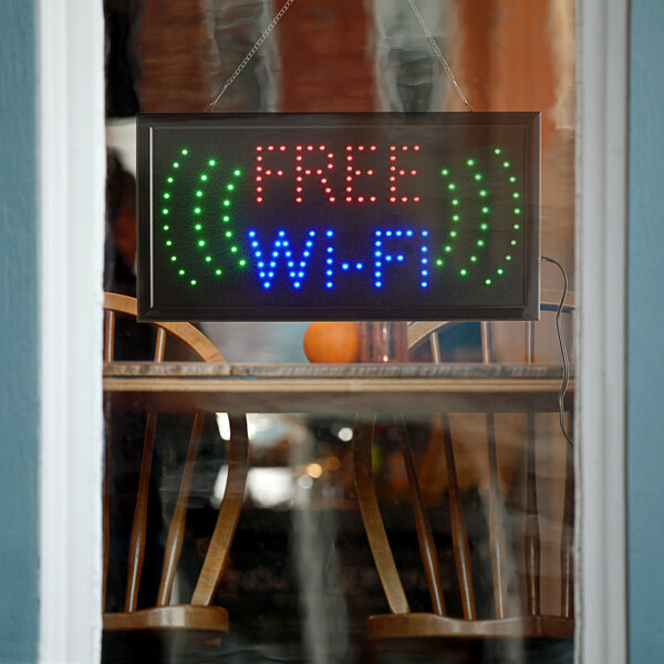 A rectangular LED sign that says "Free WiFi" in a window.