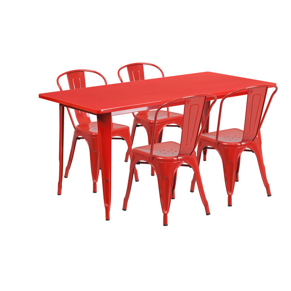 A red rectangular metal table with chairs set up in a restaurant outdoor dining area.
