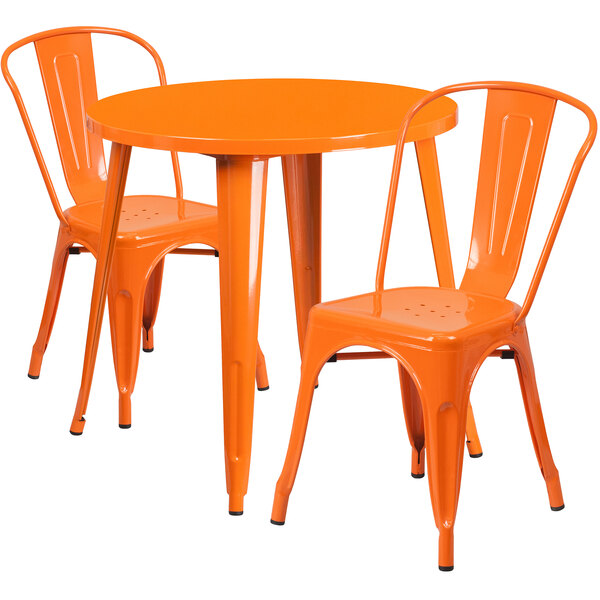 An orange metal table with two chairs.