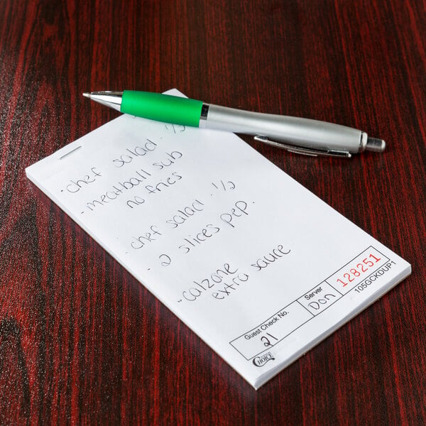 A green pen on a white Choice 1 guest check pad.