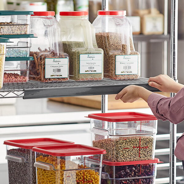 A woman holding a clear plastic container with a Metro label on a shelf full of food.