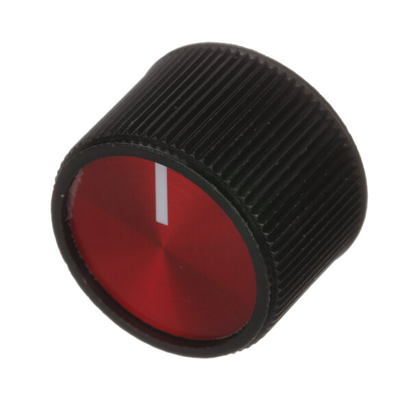 A close-up of a black and red knob with a white stripe.