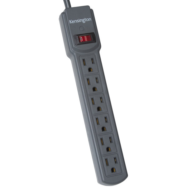 A close-up of a Kensington 6-outlet power strip with a red light on it.