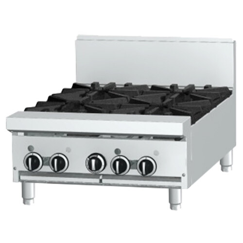 A white Garland countertop gas range with black knobs and a stainless steel top with four burners.