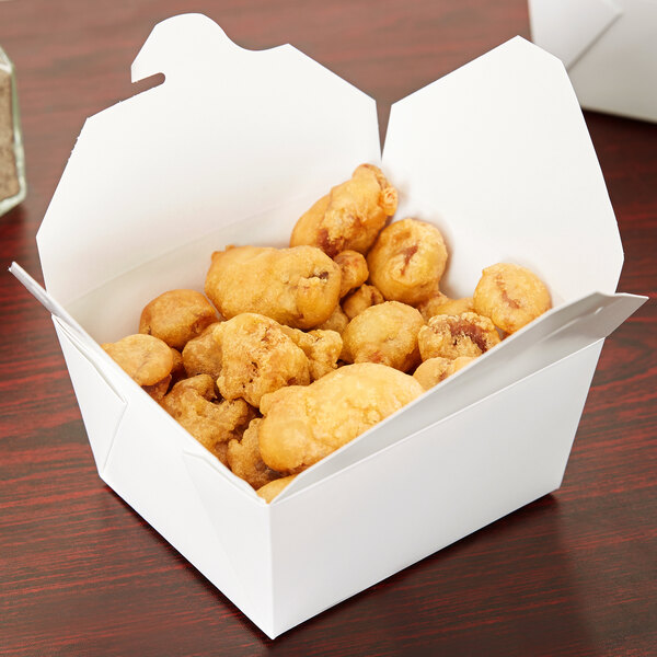 A white Fold-Pak Bio-Pak take-out box filled with fried chicken.