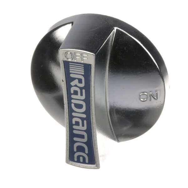 A silver German Knife range knob with a blue and white label.