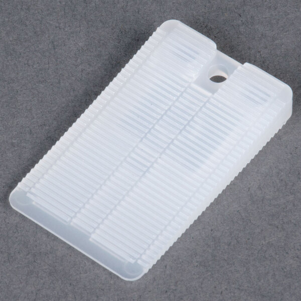 A white plastic Wobble Wedge with holes.
