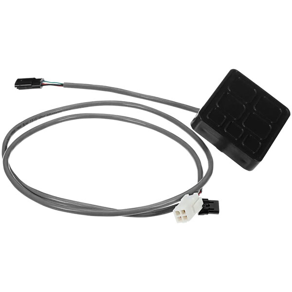 A black square electronic device with wires.