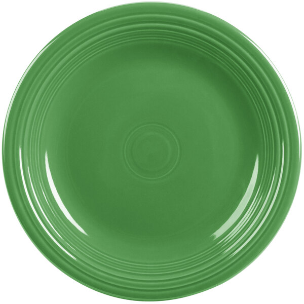 A green Fiesta dinner plate with a circular rim.