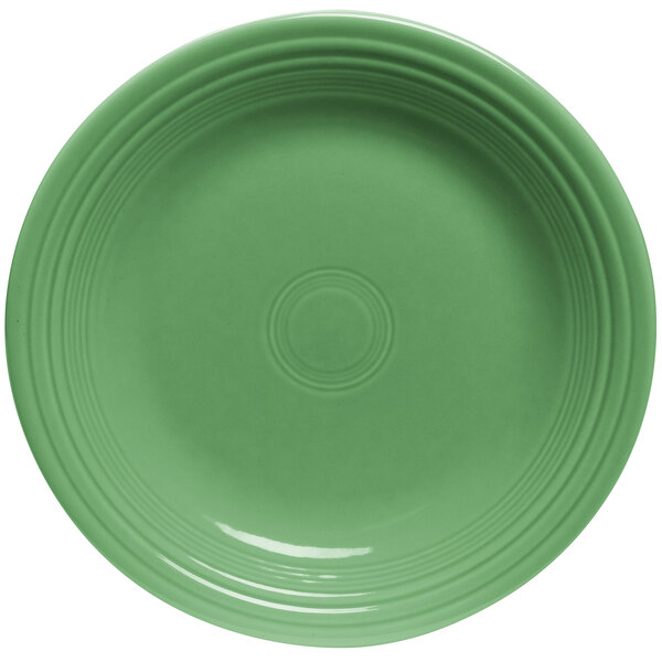 A close-up of a green Fiesta® china salad plate with a circular pattern on the rim.