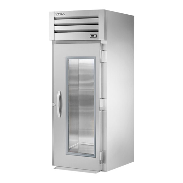 A True stainless steel roll-in refrigerator with glass doors.