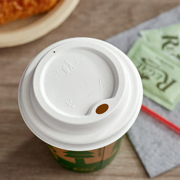 A white EcoChoice compostable lid on a coffee cup.