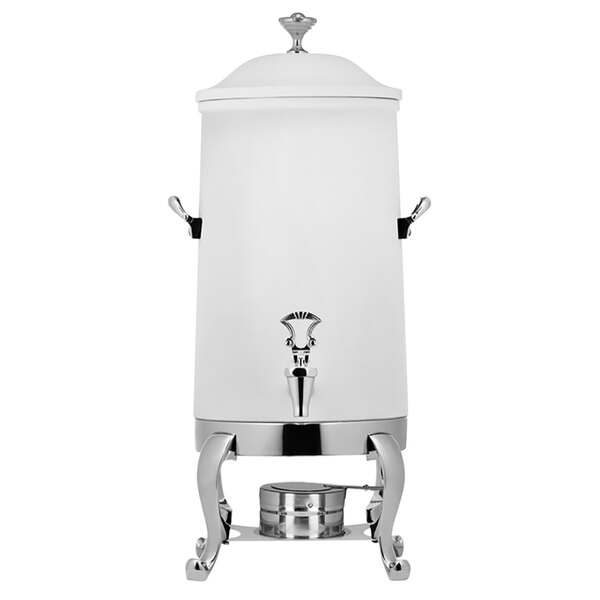A white stainless steel coffee urn with brass trim on a metal stand.