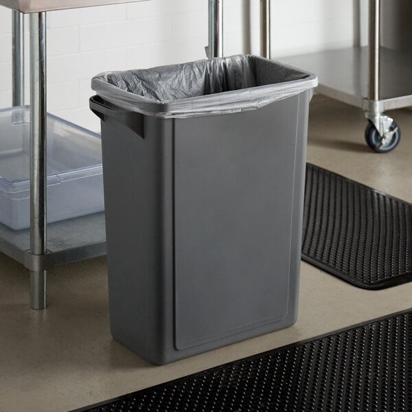 A Lavex gray rectangular trash can with a plastic bag in it.