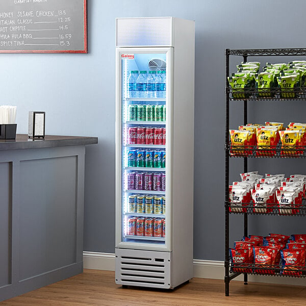A Galaxy GDN-5 merchandising refrigerator with drinks and snacks on shelves.