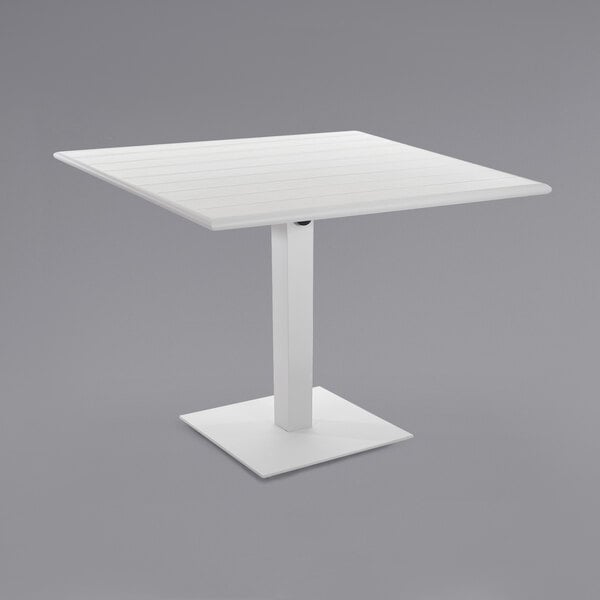 A white square BFM Seating Beachcomber-Margate table with a square metal base.