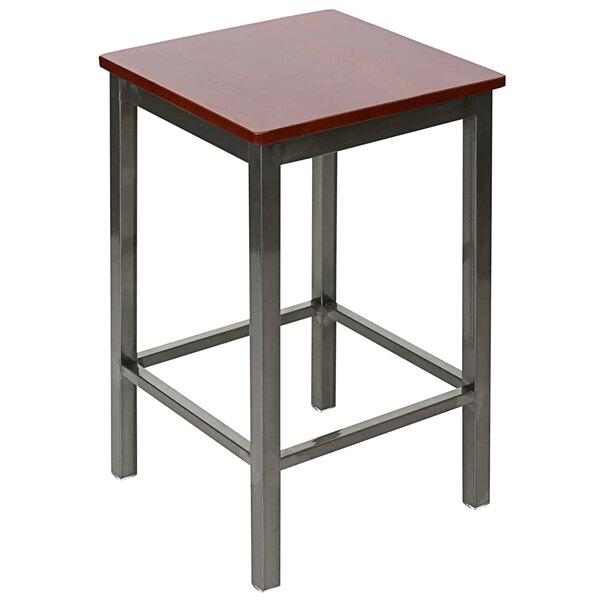 A BFM Seating Trent clear coated steel counter height bar stool with a mahogany wooden seat on a square table in a bar.