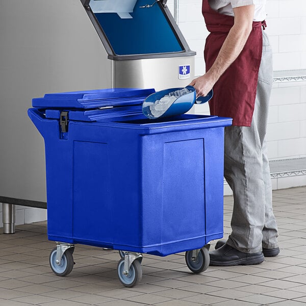 A man putting a blue container into a blue CaterGator mobile ice bin.