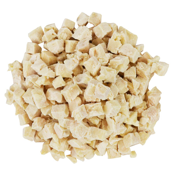 A pile of diced Brakebush chicken on a white background.