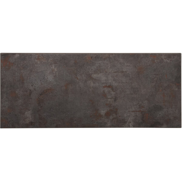 A BFM Seating rectangular melamine table top with a grey surface and brown spots resembling rust.