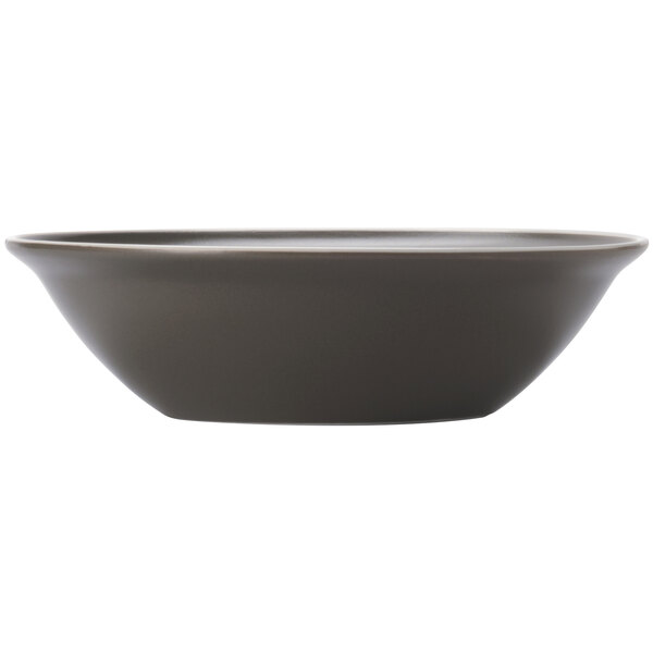 A white porcelain bowl with a matte olive interior and a dark brown rim.