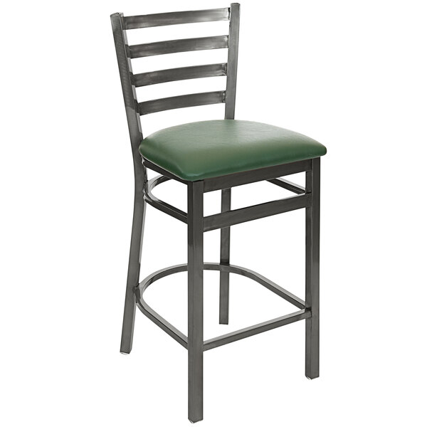 A BFM Seating counter height bar stool with a green vinyl seat and back.