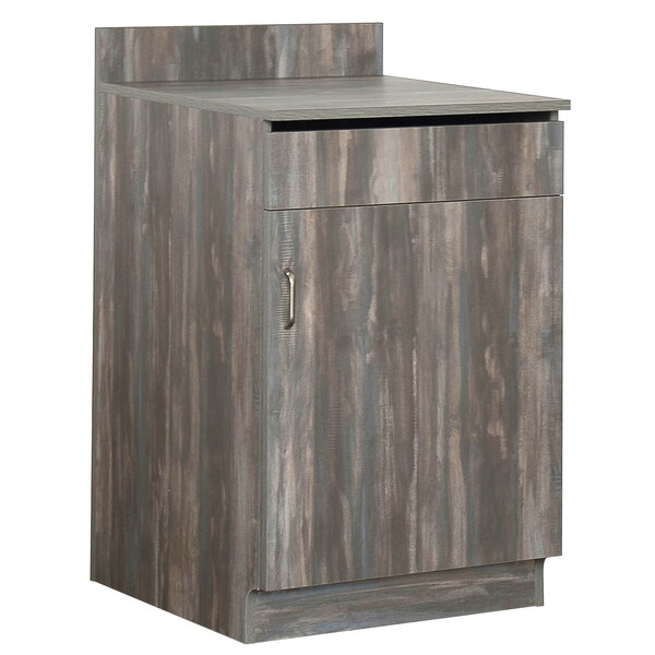 A wooden cabinet with a door on a counter.