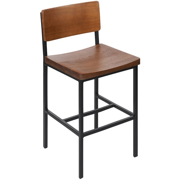 A BFM Seating Memphis bar stool with a wooden seat and back on a black frame.